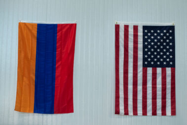 The Aramean and the America Flag hanging on a wall together.