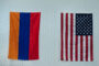 The Aramean and the America Flag hanging on a wall together.