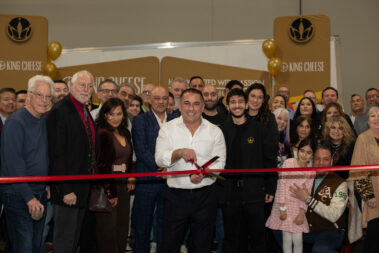 Vicken Aghchikian cutting a red ribbon at the their Grand Opening.