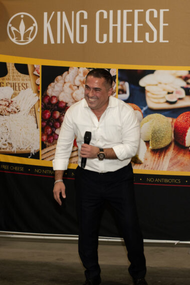 Vicken Aghchikian smiling as he talking to a audience.