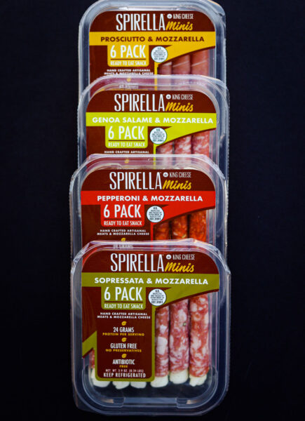 Spriella mini cheeses packages on a black background.