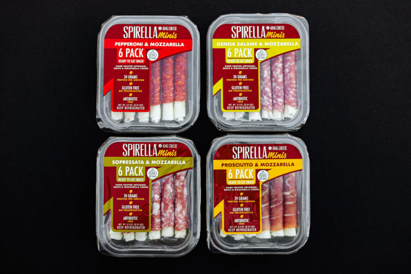 Packages of a varieties of imported cheeses for King Cheese on a transparent background.