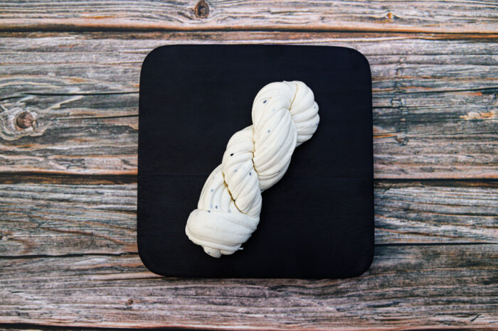 String cheese from King Cheese original flavor on a wooden table.