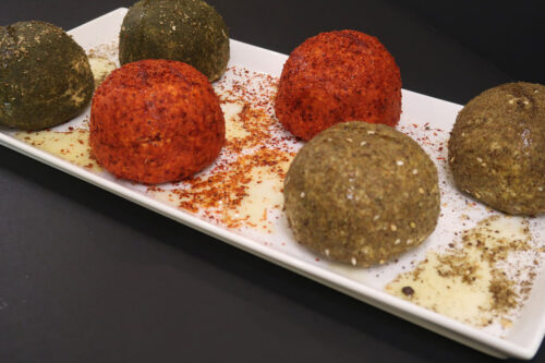 Feta cheese balls on a plate.