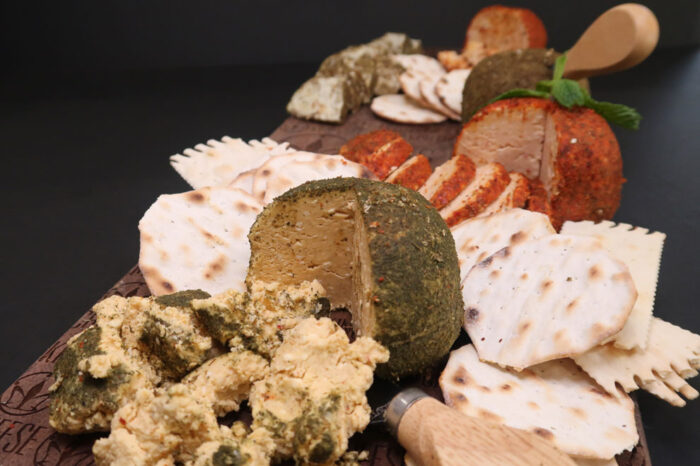 Various feta cheeses on a wooden plater.